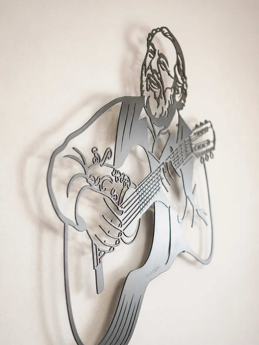 The portrait seen at an angle — the space from the wall and the shadow behind it