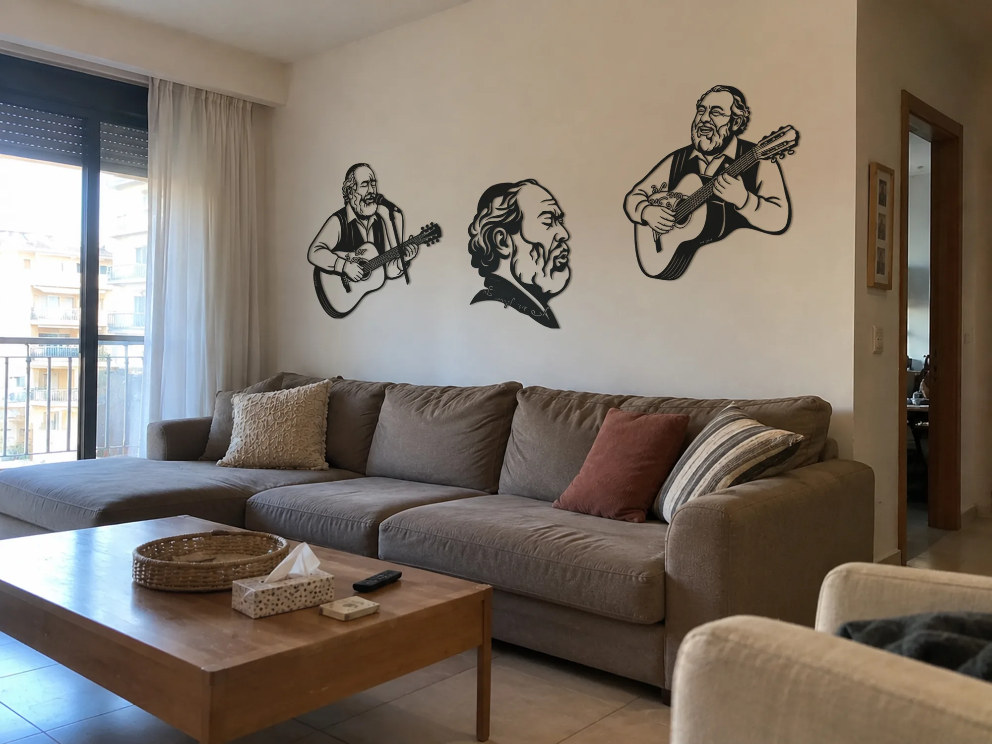 All three portraits above a sofa in a bright living room